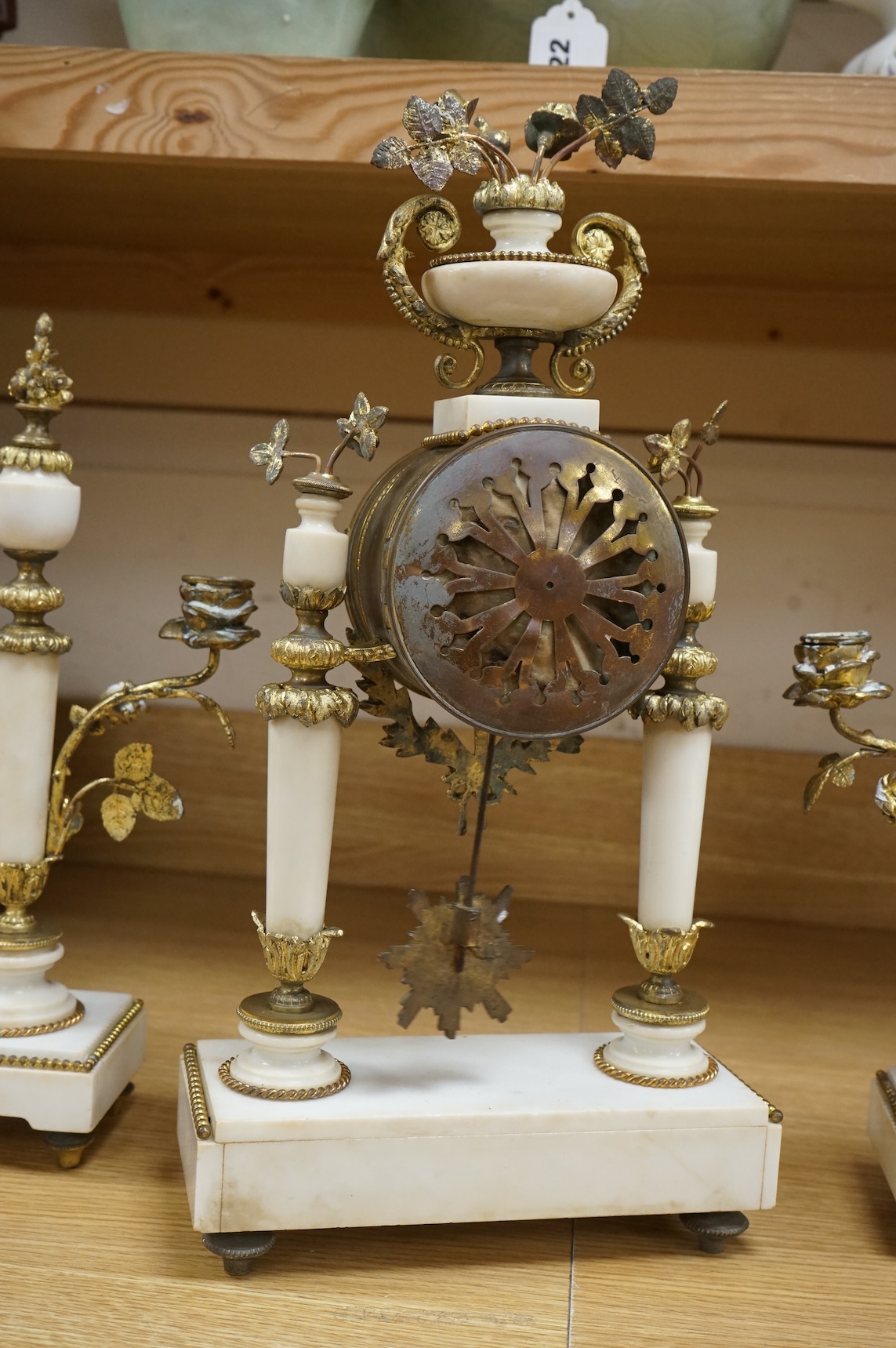 A 19th French white marble and gilt metal clock garniture, c.1900, striking on a bell, with pendulum, 45cm high